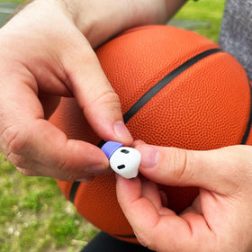 COMPLY lifestyle runner using AirPods showing anti-slip hold