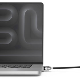 Compulocks adapter beside coin showing compact size and travel friendly