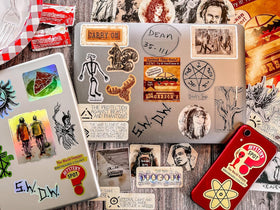 CON*QUEST stickers on laptop demonstrating scale and customization benefit