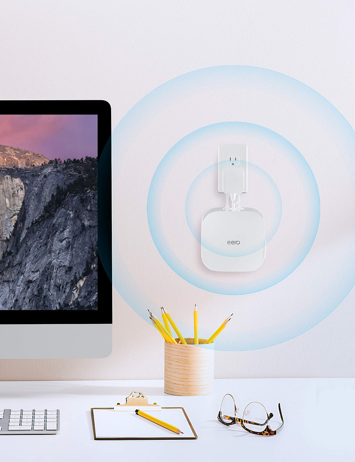 COOLWUFAN held in hand next to eero showing compact size and portability