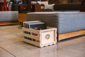 Crosley crate in use with records inside, demonstrates portability and browsing convenience