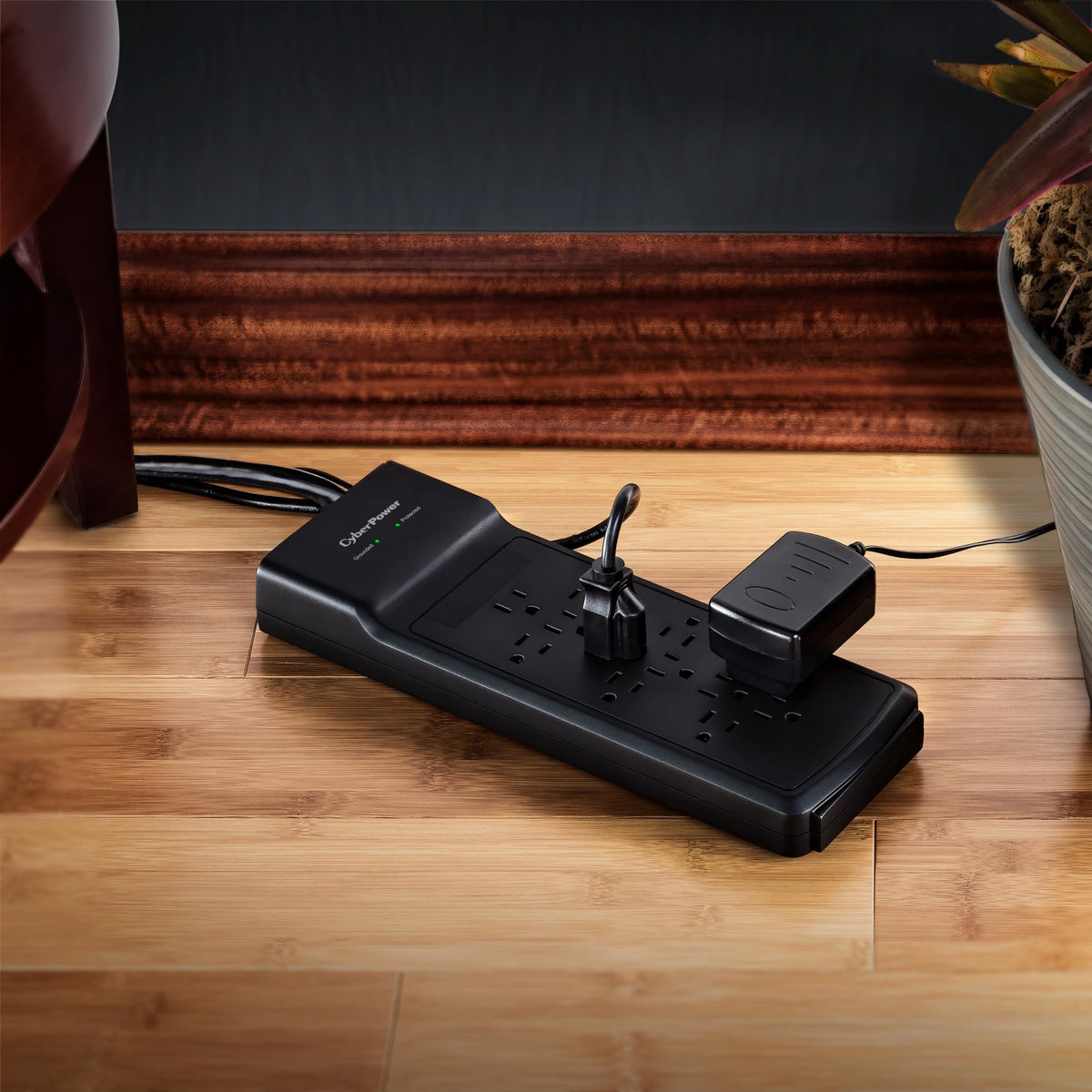 CyberPower shown next to a power brick and phone for scale and outlet compatibility