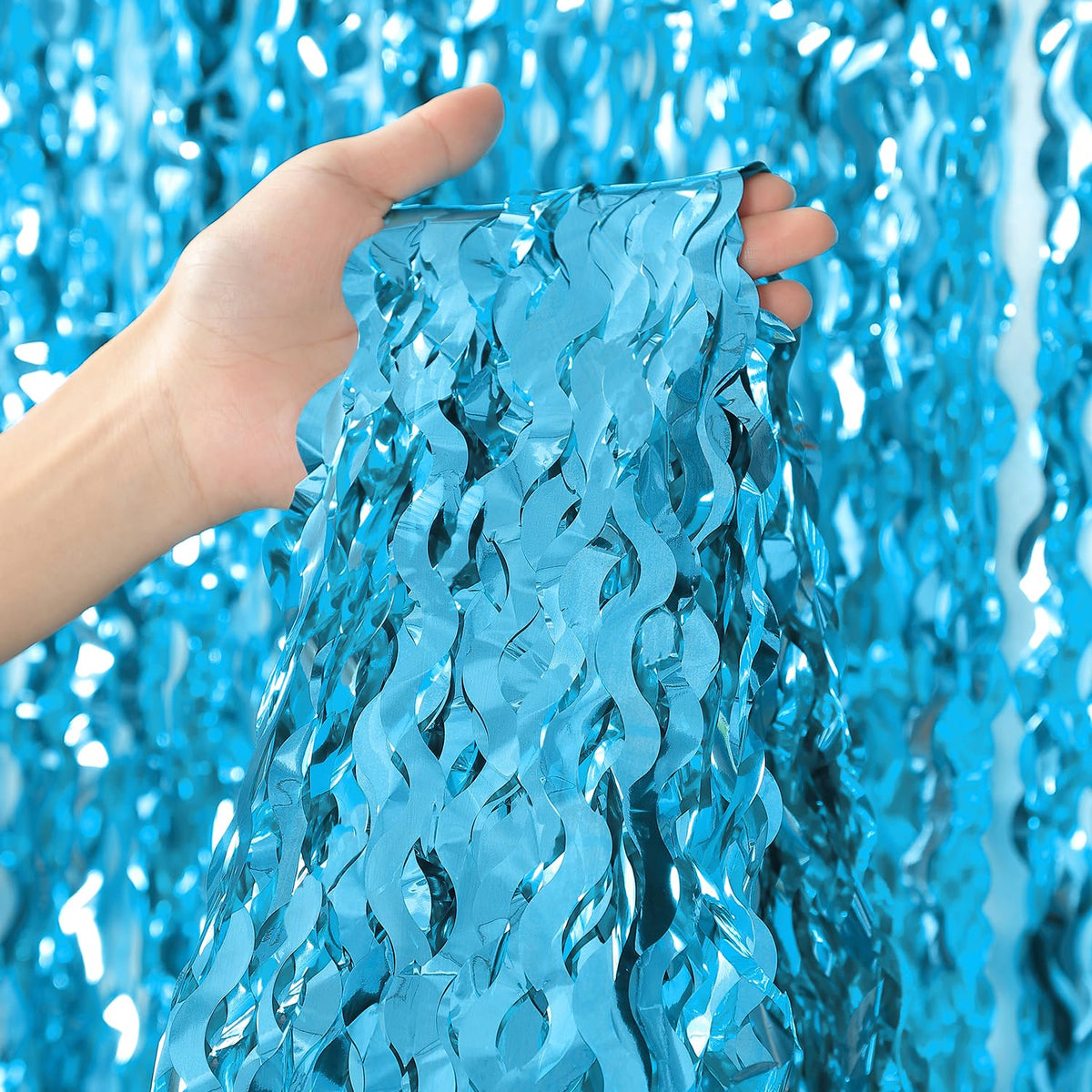 cylmfc blue fringe curtain close-up showing shimmering metallic texture.