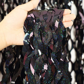 CYLMFC black foil curtain closeup highlights shiny metallic texture for festive decor.