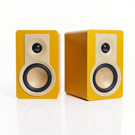 DALI KUPID Golden Yellow wall brackets mounted on the side of the speaker show flexible placement options.