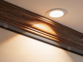 Delamu installed behind a wall-mounted TV illustrating tidy setup and safer living space
