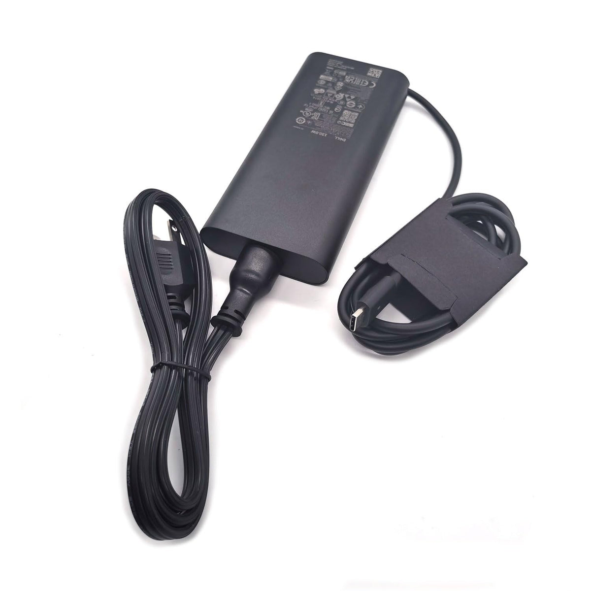 Dell 130W USB-C adapter side view, compact design for desk setups.
