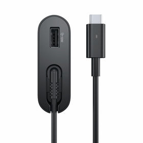Dell adapter beside laptop for scale showing compact travel-friendly size