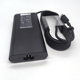 Dell charger next to ruler showing compact size and easy storage