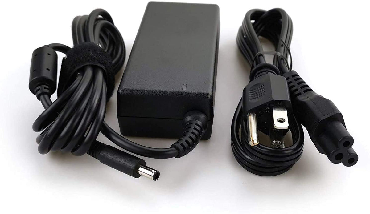 Dell Inspiron 65W charger on desk with laptop ready to power up.