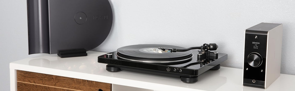Denon DP-450USB tonearm closeup shows curved tracking for gentle record handling.