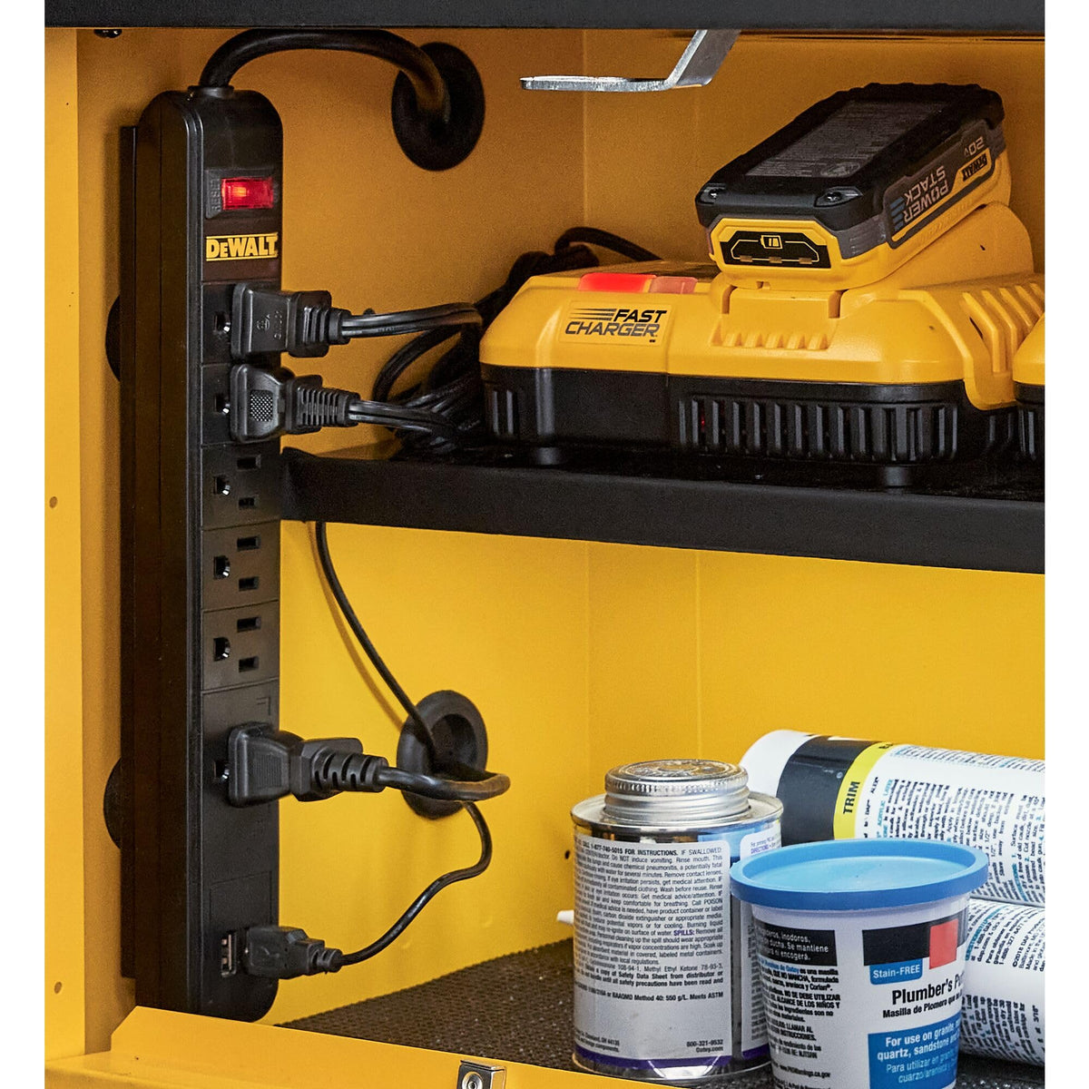 DEWALT power strip in garage setting powering tools and phones for efficient workspace use