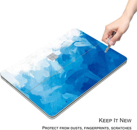 Digi-Tatoo blue paint design on Surface Laptop Studio 2 skin highlights personal style while guarding against scratches