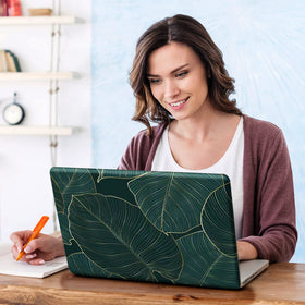 DINKY green leaf laptop skin with removable layer demonstrates residue-free peel.