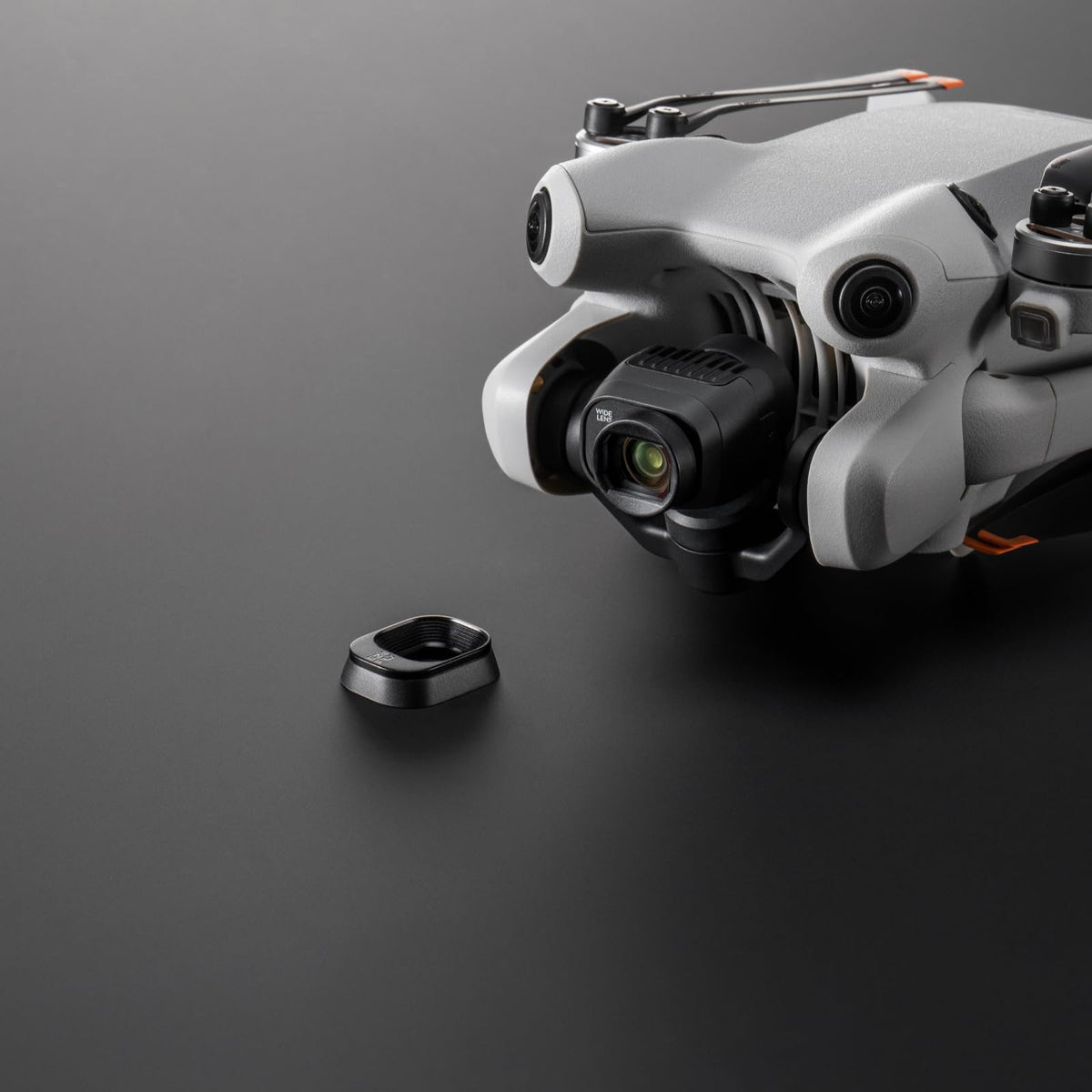 DJI lens beside a hand for scale to show compact portable benefit