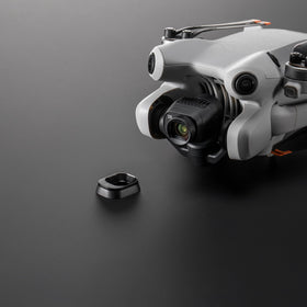 DJI lens beside a hand for scale to show compact portable benefit