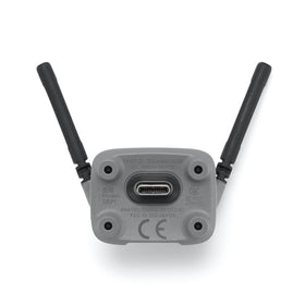 DJI Neo 2 transceiver installed on drone with controller nearby, enabling stable live video