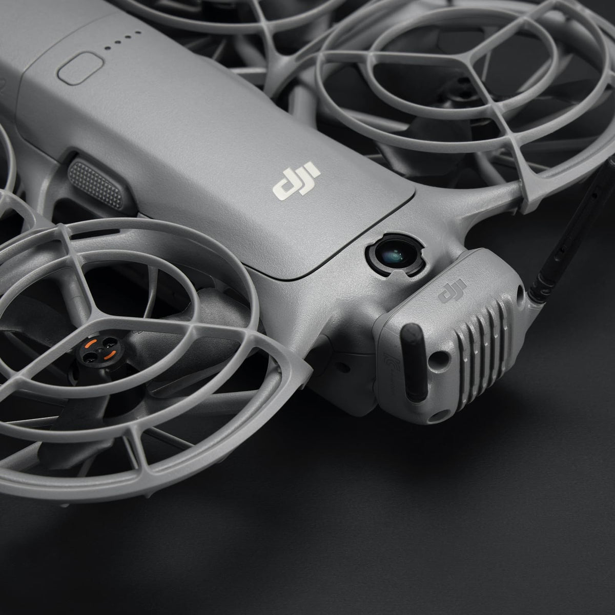 DJI Neo 2 transceiver size comparison next to a coin, illustrating compact DJI convenience