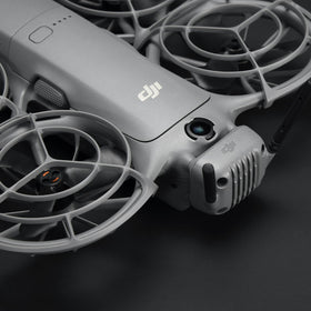DJI Neo 2 transceiver size comparison next to a coin, illustrating compact DJI convenience