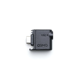 DJI Osmo Audio Adapter attached for stable 3.5mm mic input on the move