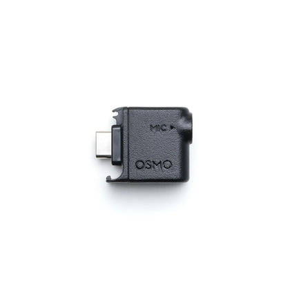 DJI Osmo Audio Adapter attached for stable 3.5mm mic input on the move