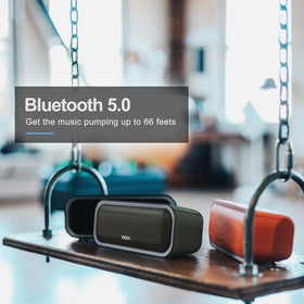 DOSS SoundBox Pro next to water bottle for scale, showing compact travel-friendly size