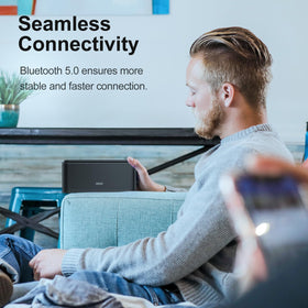 DOSS SoundBox Touch in hand showing compact size and portability