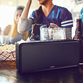 DOSS SoundBox XL in a living-room lifestyle scene for party-ready audio benefit