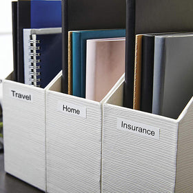 DYMO labels used in home office on bins and files showcasing organization and neat appearance
