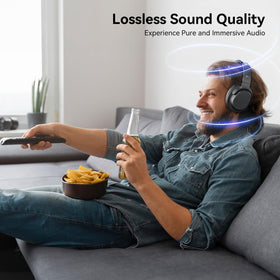 Dytole headphones worn by a viewer watching TV for clear, comfortable sound.