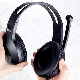 Eduvy headset beside textbook showing compact size and classroom scale