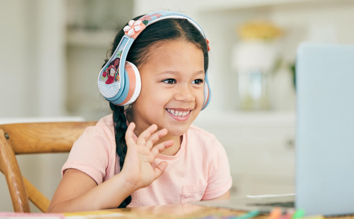 child wearing eKids Moana headphones watching a tablet for school or entertainment