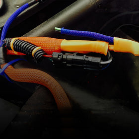 Electriduct sleeving fitted on computer cables demonstrating organized workspace benefit
