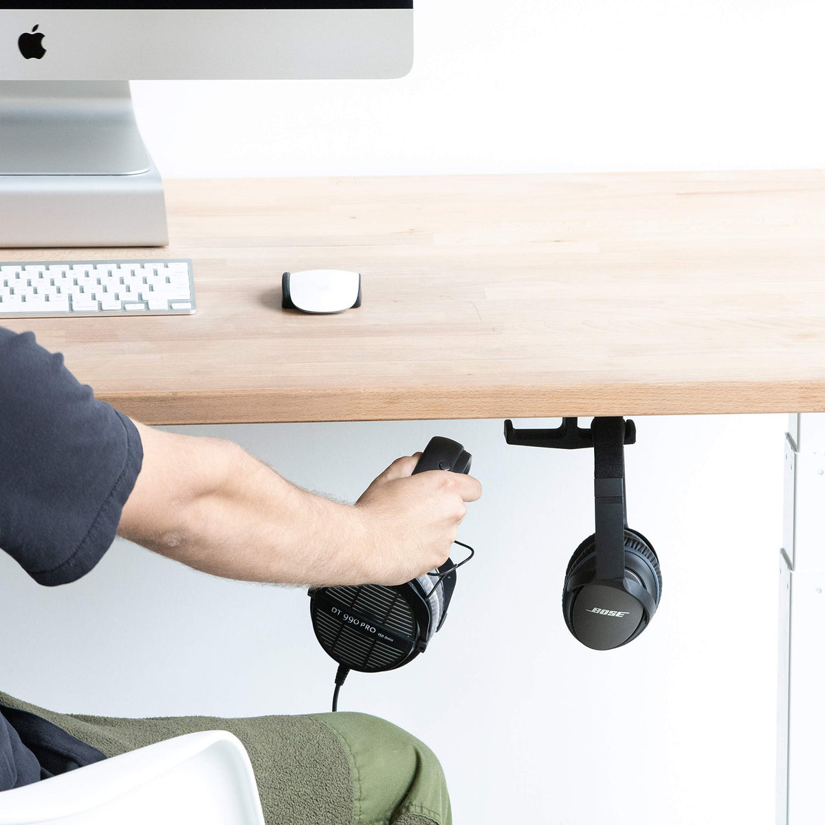 Elevation Lab Anchor in-use with two headphones within reach.