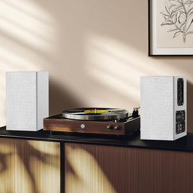 Elimavi speakers on a desk beside a laptop offering clearer meetings and media audio