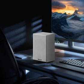 Elimavi speaker next to coffee mug illustrating compact size and easy placement