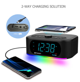 Emerson speaker in bedroom setting with lights and phone charging, enhancing nightly routine