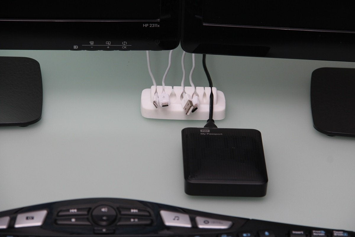 ENVISIONED compact desk cord holder shows a 7-slot layout for daily setup.