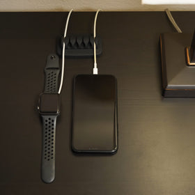 ENVISIONED weighty base preventing cables from sliding off the desk.