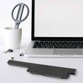 Fancy Buying battery powering a laptop in a cafe to show extended mobile use