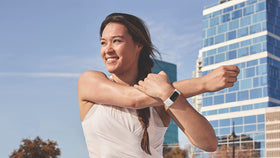 Fitbit frost white aluminum double-buckle close-up ensures secure fit