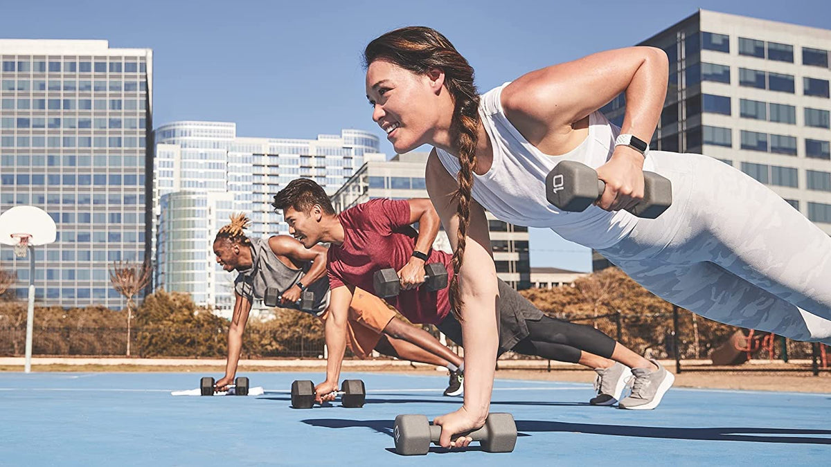 Fitbit frost white band worn on wrist in workout setting shows versatility