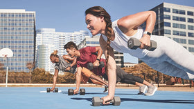 Fitbit frost white band worn on wrist in workout setting shows versatility