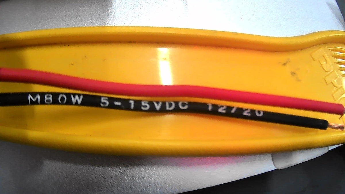 Floyd Bell audio warning device side view in red showing compact piezo alarm