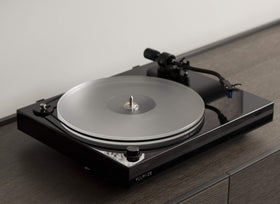 Fluance reference platter with brass spindle collar emphasizes flatness and durability.
