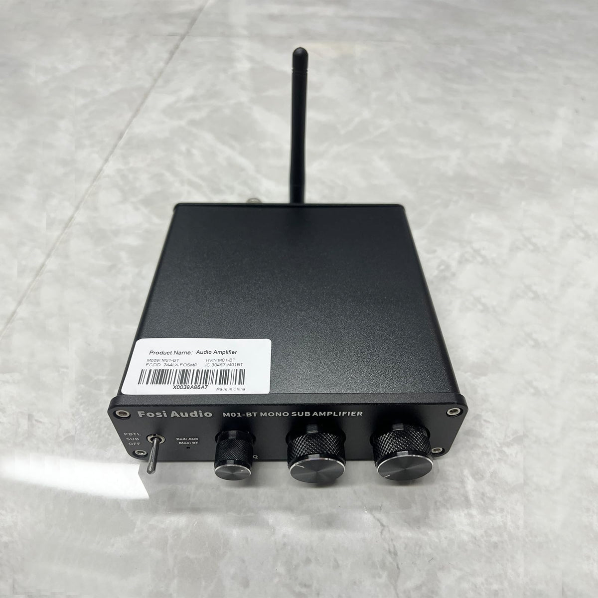 Fosi Audio M01-BT in a living room home theater setup enhancing movie bass