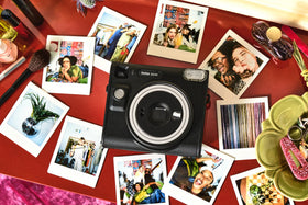 Lifestyle shot of the SQ40 with a square photo in hand.