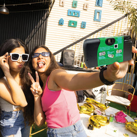 Fujifilm QuickSnap Flash in hand scale photo showing pocketable size and portability benefit