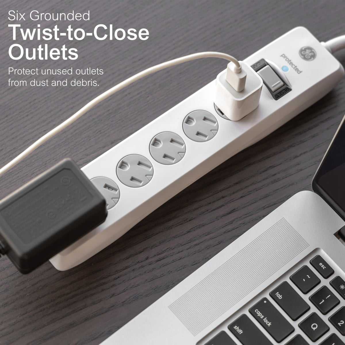 GE flat plug angled behind couch demonstrating low-profile fit to save space