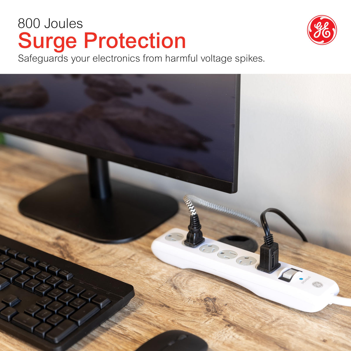 GE power strip used on a home desk organizing devices and protecting electronics